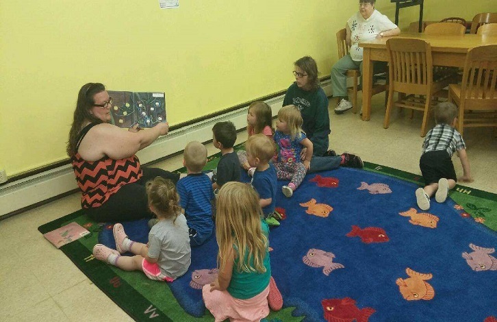 Daycare children reading at the library