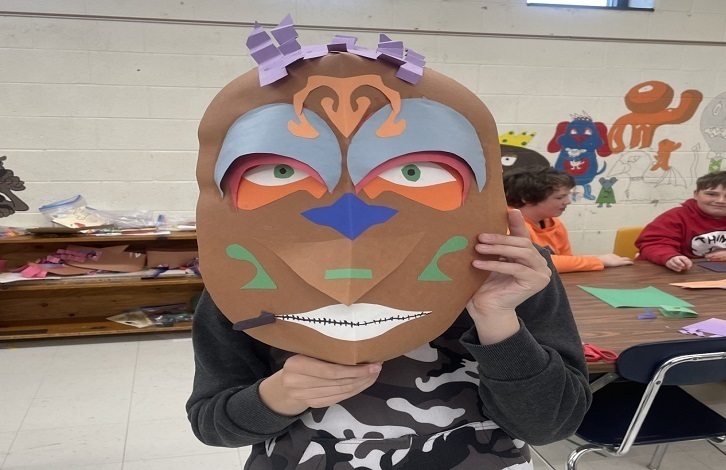 6th grade wearing a mask they made in art class