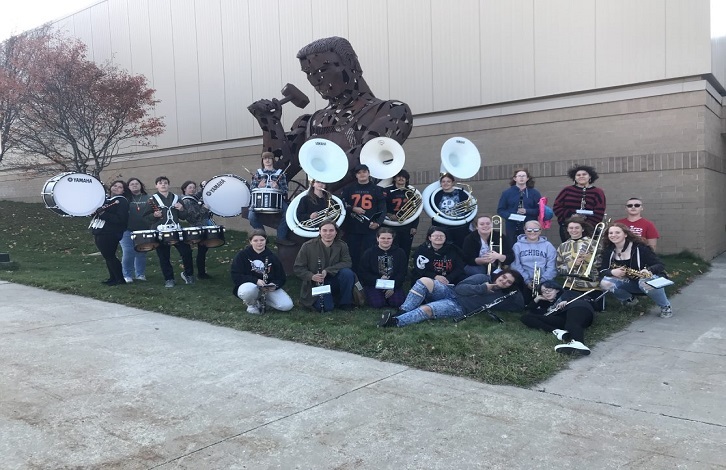 High school band in front of the Ironman at the high school