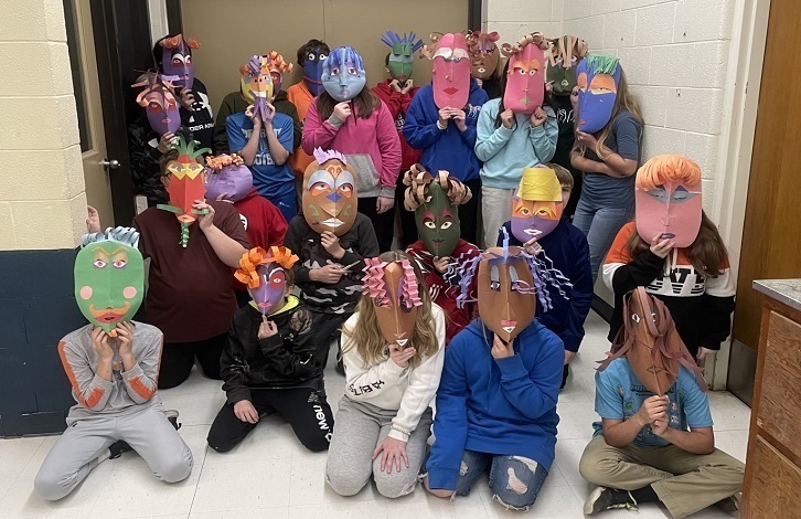 6th grade class wearing the masks they made in art class